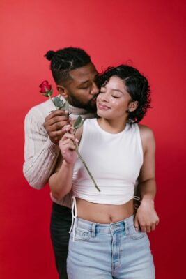Man and woman holding a rose